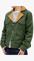 An olive green utility jacket with a tan corduroy collar, worn by a model over a gray t-shirt and dark blue jeans against a white background.