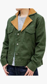 An olive green utility jacket with a tan corduroy collar, worn by a model over a gray t-shirt and dark blue jeans against a white background.