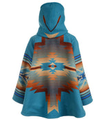 A hooded cape-style poncho with a vibrant turquoise blue base and a large Southwestern geometric pattern in orange, beige, and brown on the back, shown against a plain white background.